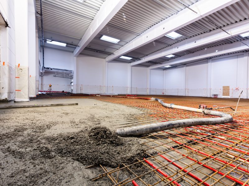 Concrete screed on floor heating in a new warehouse and office building