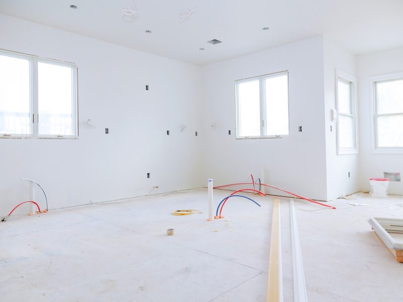 Interior construction of housing project with drywall installed and patched without building is a