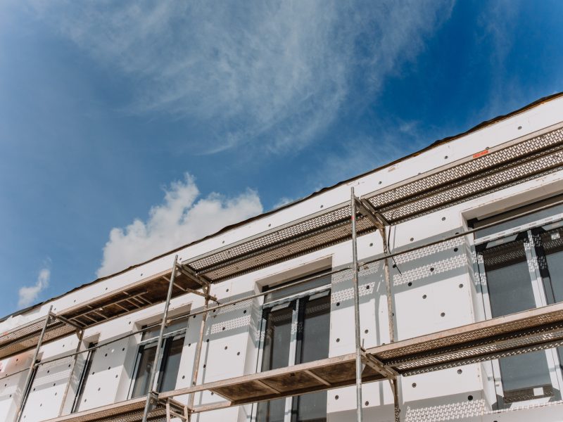 scaffolding on house facade,modern building under construction -